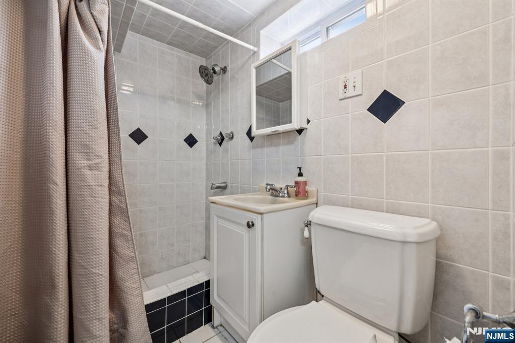 18 Scher Place Passaic, NJ 07055 - Photo 19 of 22 a white toilet sitting next to a bathroom sink