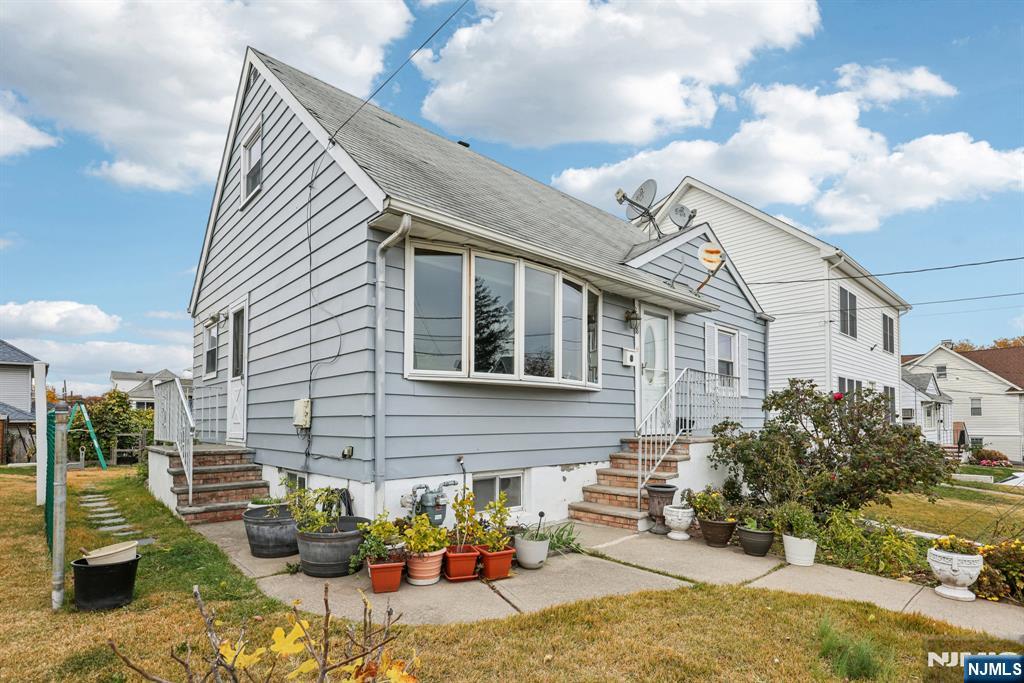 18 Scher Place Passaic, NJ 07055 - Photo 2 of 22 a front view of a house with a yard