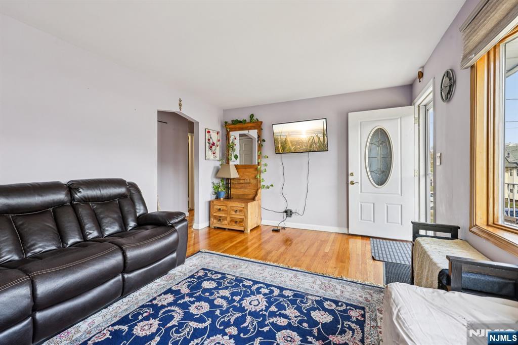 18 Scher Place Passaic, NJ 07055 - Photo 6 of 22 a living room with furniture and a flat screen tv