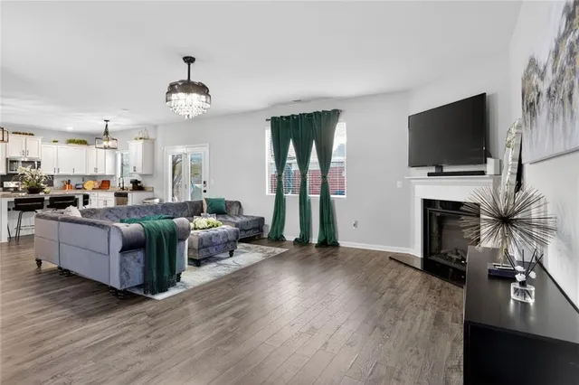 a living room with furniture and a chandelier
