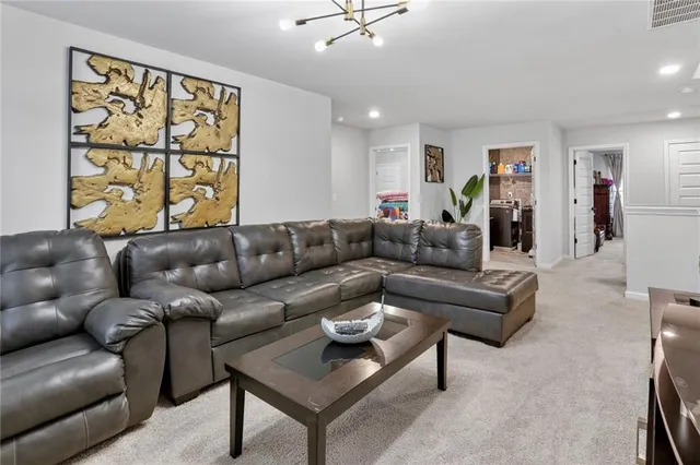 a living room with furniture a flat screen tv and a window