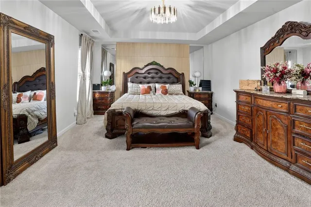 a bedroom with a bed and a chandelier