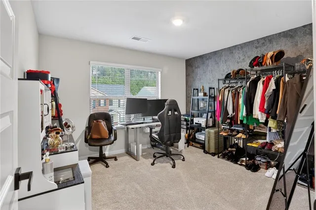 a view of a hallway with wooden floor and furniture