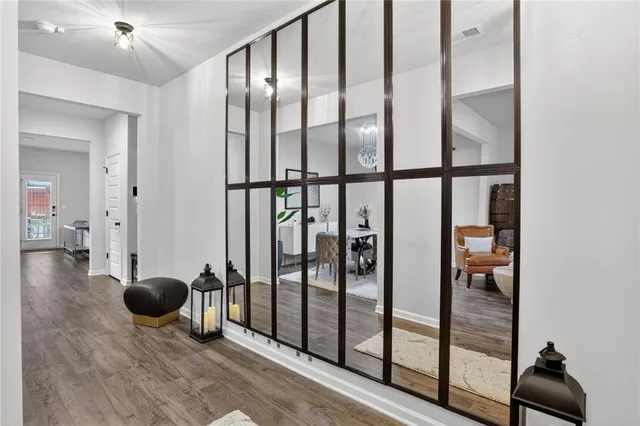 a living room with furniture and wooden floor