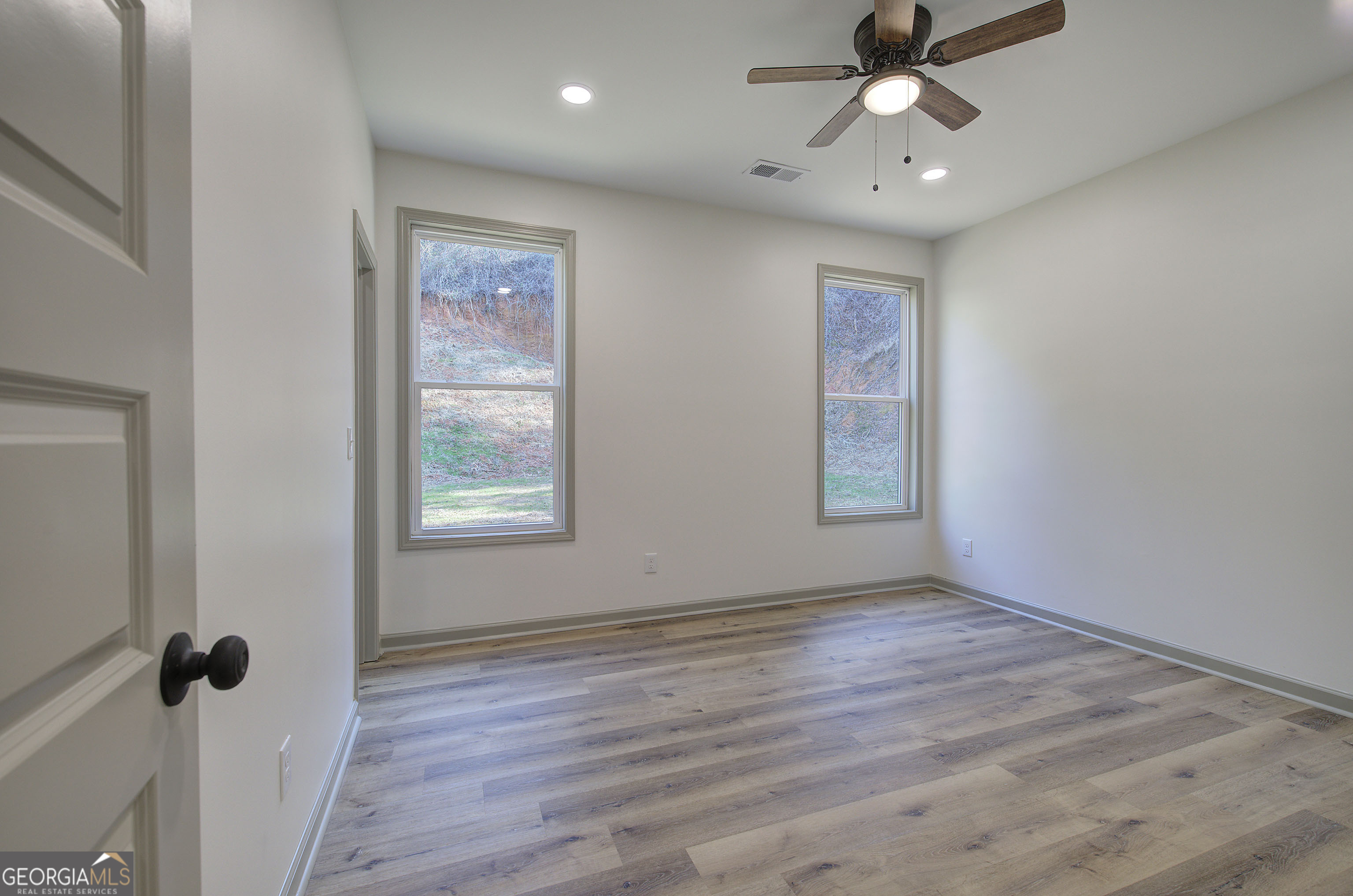 117 East Boundary Street Southeast Rome, GA 30161 - Photo 16 of 36 a view of an empty room with a window and wooden floor