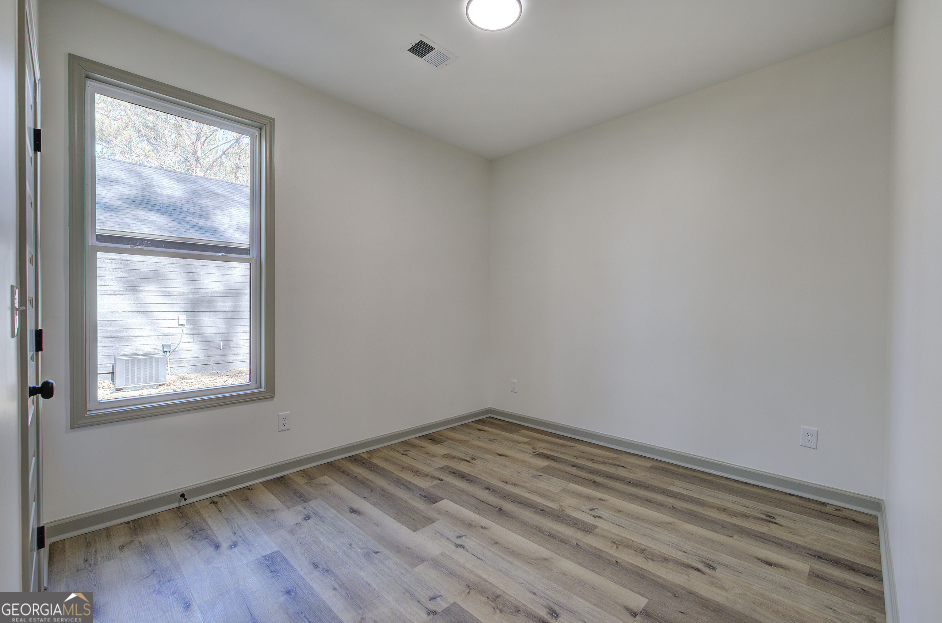 117 East Boundary Street Southeast Rome, GA 30161 - Photo 25 of 36 an empty room with wooden floor and windows