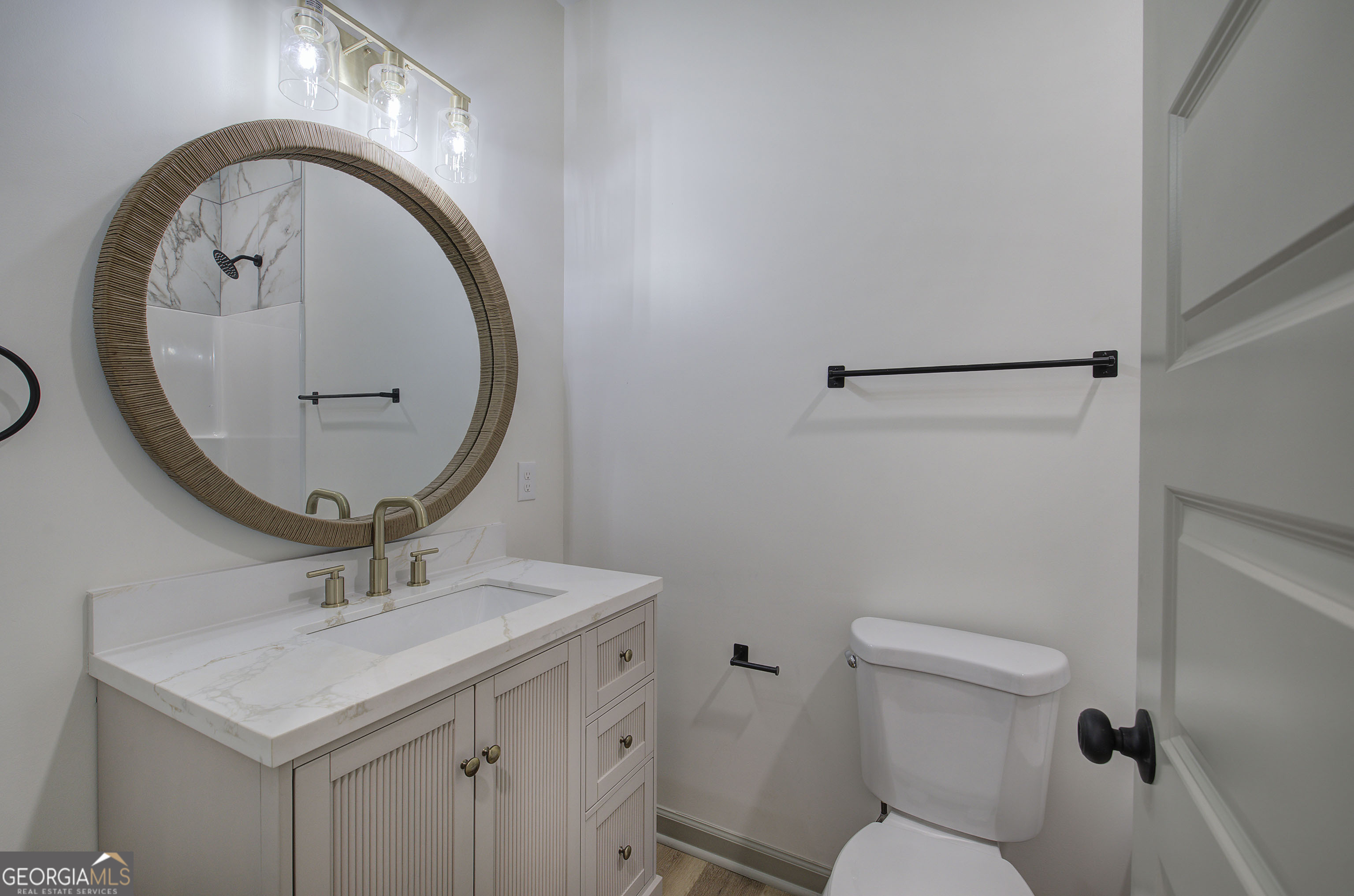 117 East Boundary Street Southeast Rome, GA 30161 - Photo 27 of 36 a bathroom with a sink a mirror and a toilet