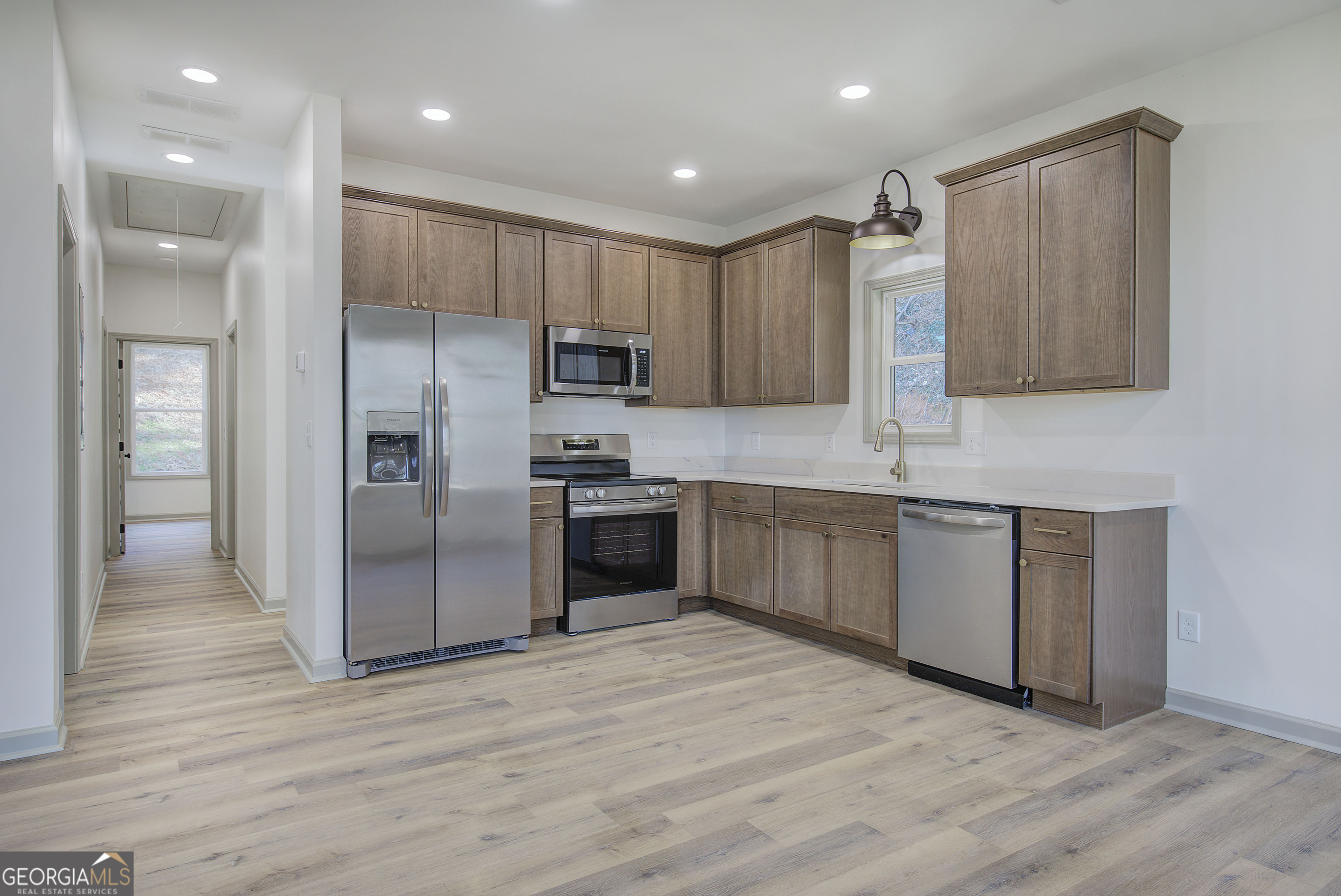 117 East Boundary Street Southeast Rome, GA 30161 - Photo 7 of 36 a kitchen with kitchen island granite countertop wooden floors stainless steel appliances a sink