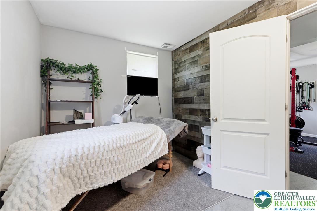 732 Bushkill Center Road Nazareth, PA 18064 - Photo 28 of 43 A versatile interior space featuring a textured wood accent wall and comfortable appointments, ideal for a private home office or studio.