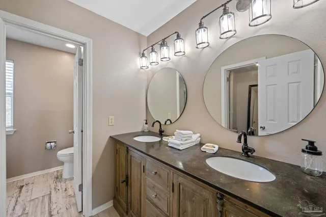 a bathroom with a double vanity sink and a mirror
