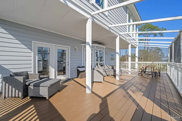 a view of a balcony with wooden floor and outdoor seating