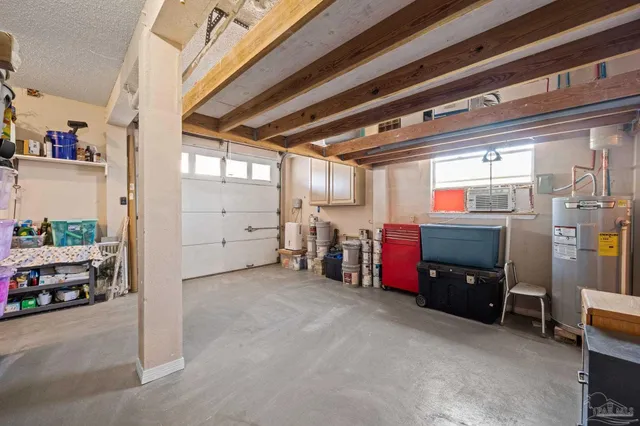 a living room with furniture a air conditioner and a window