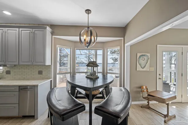 a view of a dining room with furniture wooden floor and chandelier