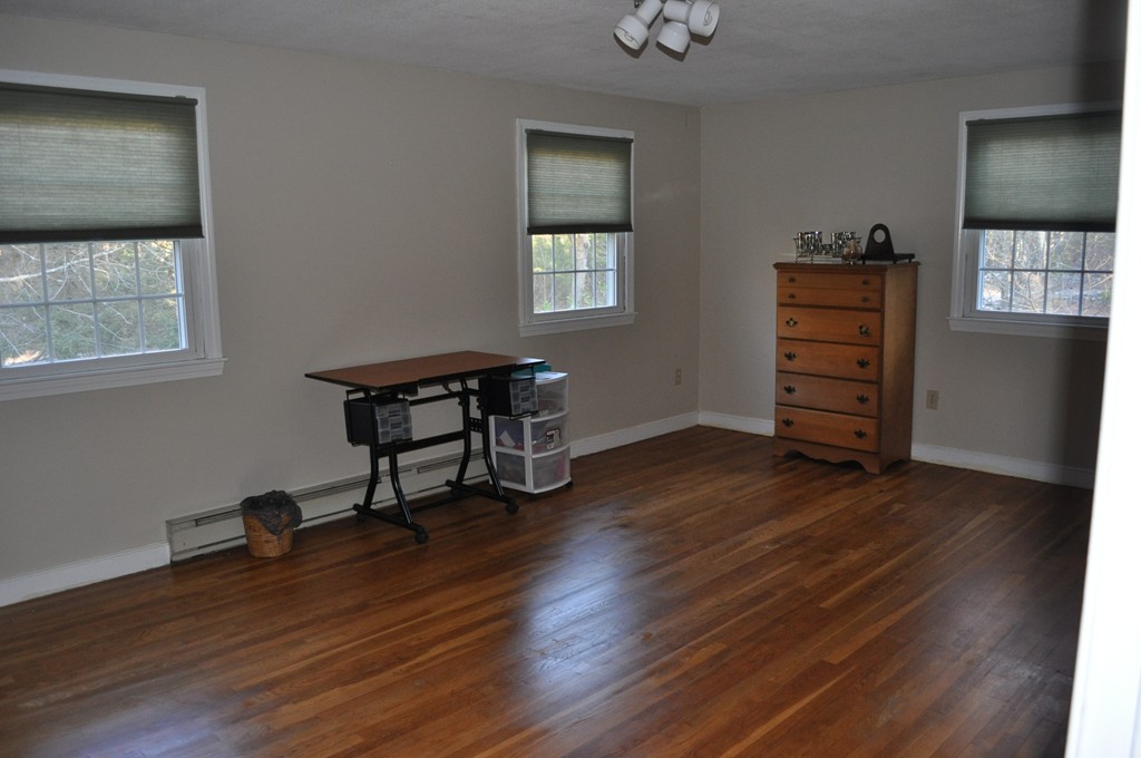 208 Worcester Road Princeton, MA 01541 - Photo 14 of 15 a view of a workspace with wooden floor and a window