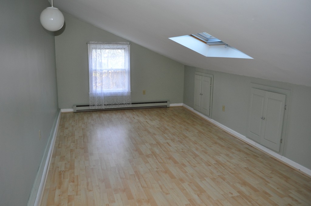 208 Worcester Road Princeton, MA 01541 - Photo 15 of 15 an empty room with wooden floor and windows