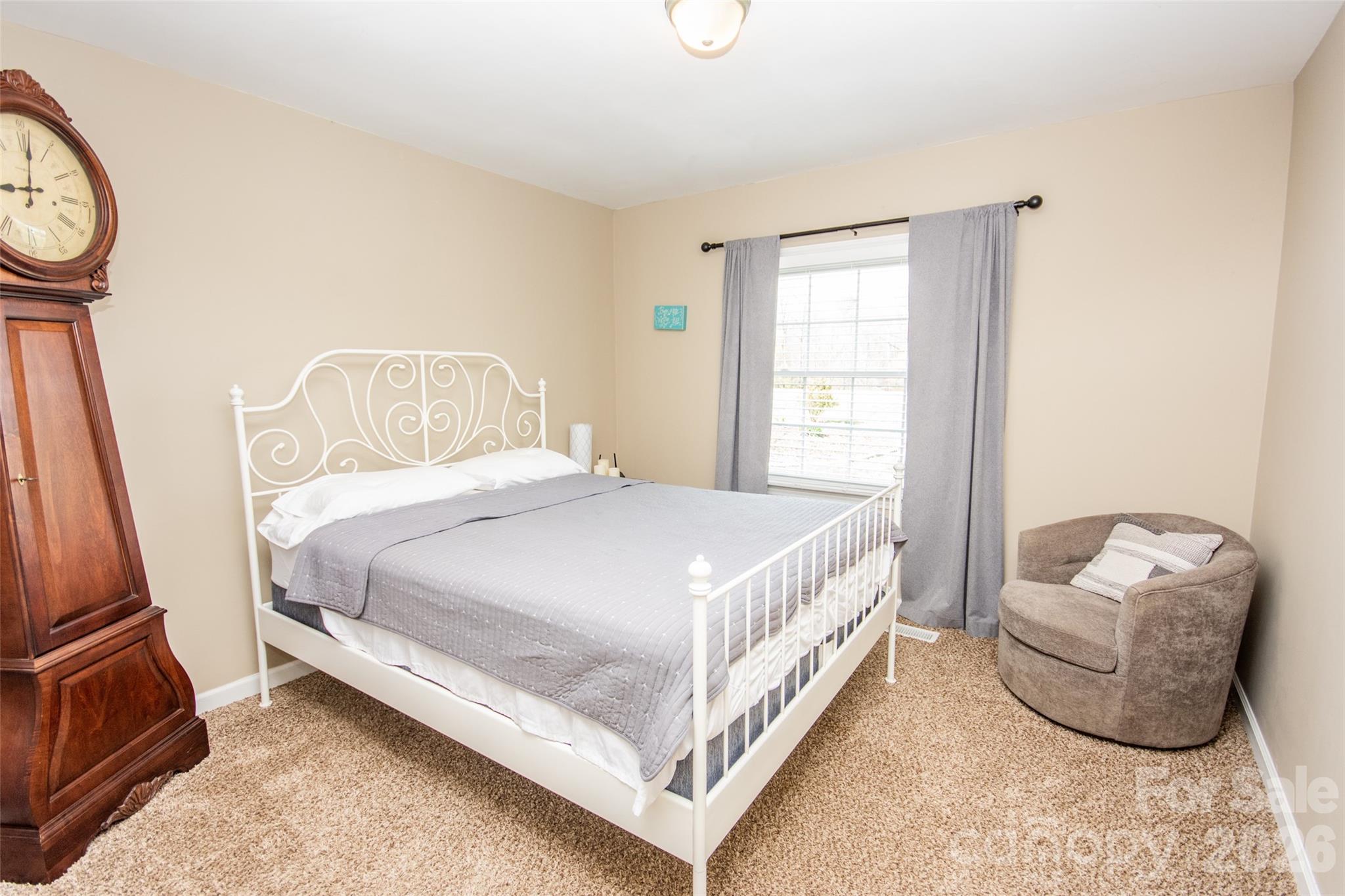 455 Mitch Road Union Grove, NC 28689 - Photo 20 of 44 a bedroom with a bed and a closet with wooden floor