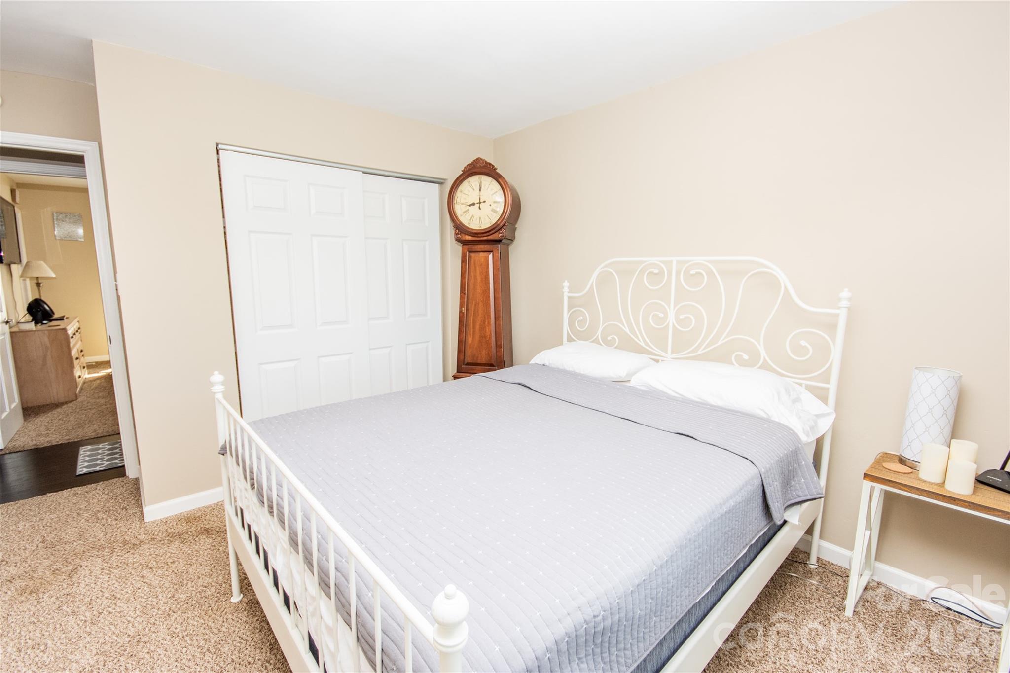 455 Mitch Road Union Grove, NC 28689 - Photo 21 of 44 a bedroom with a bed and a chandelier