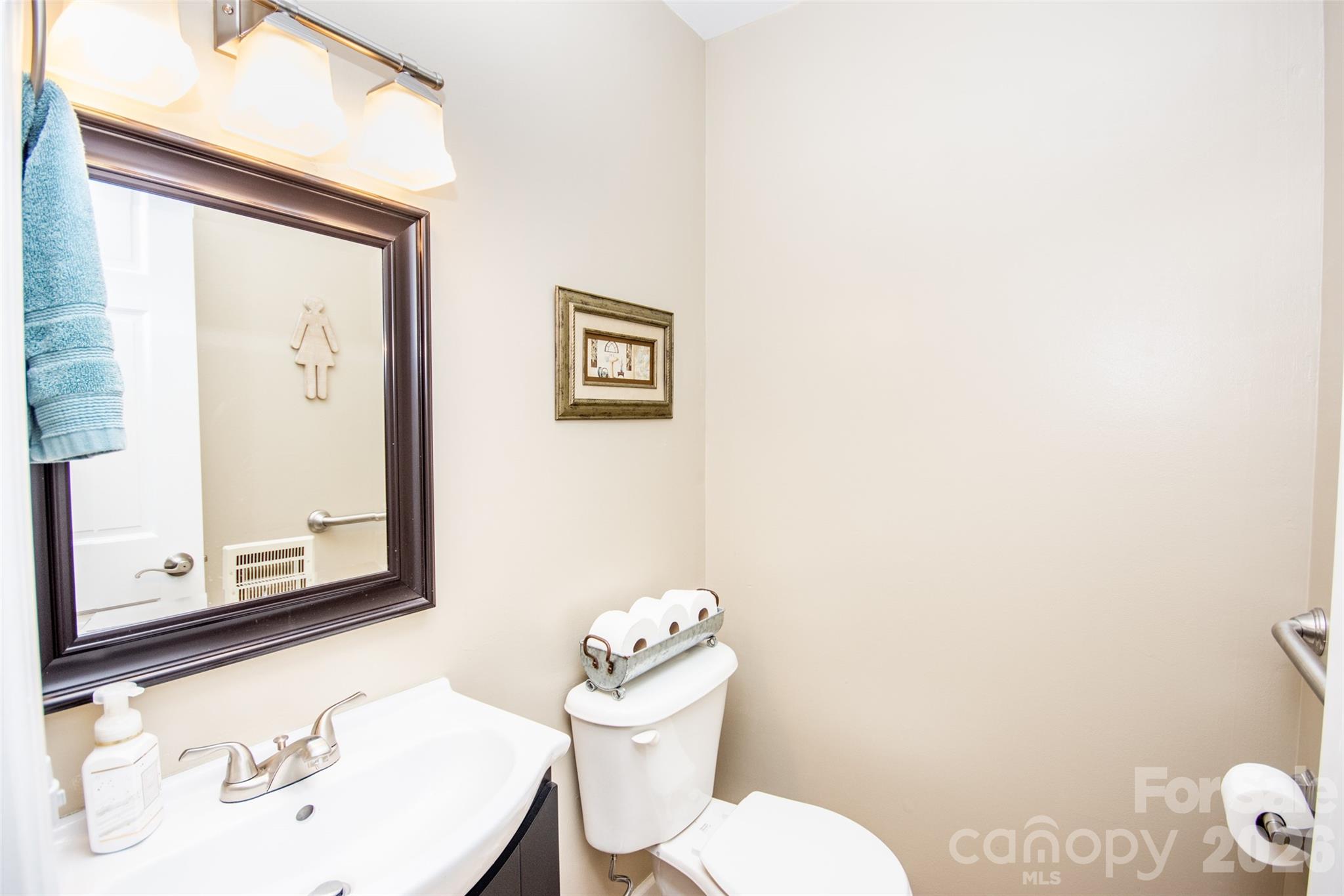 455 Mitch Road Union Grove, NC 28689 - Photo 23 of 44 a bathroom with a toilet a sink and a mirror