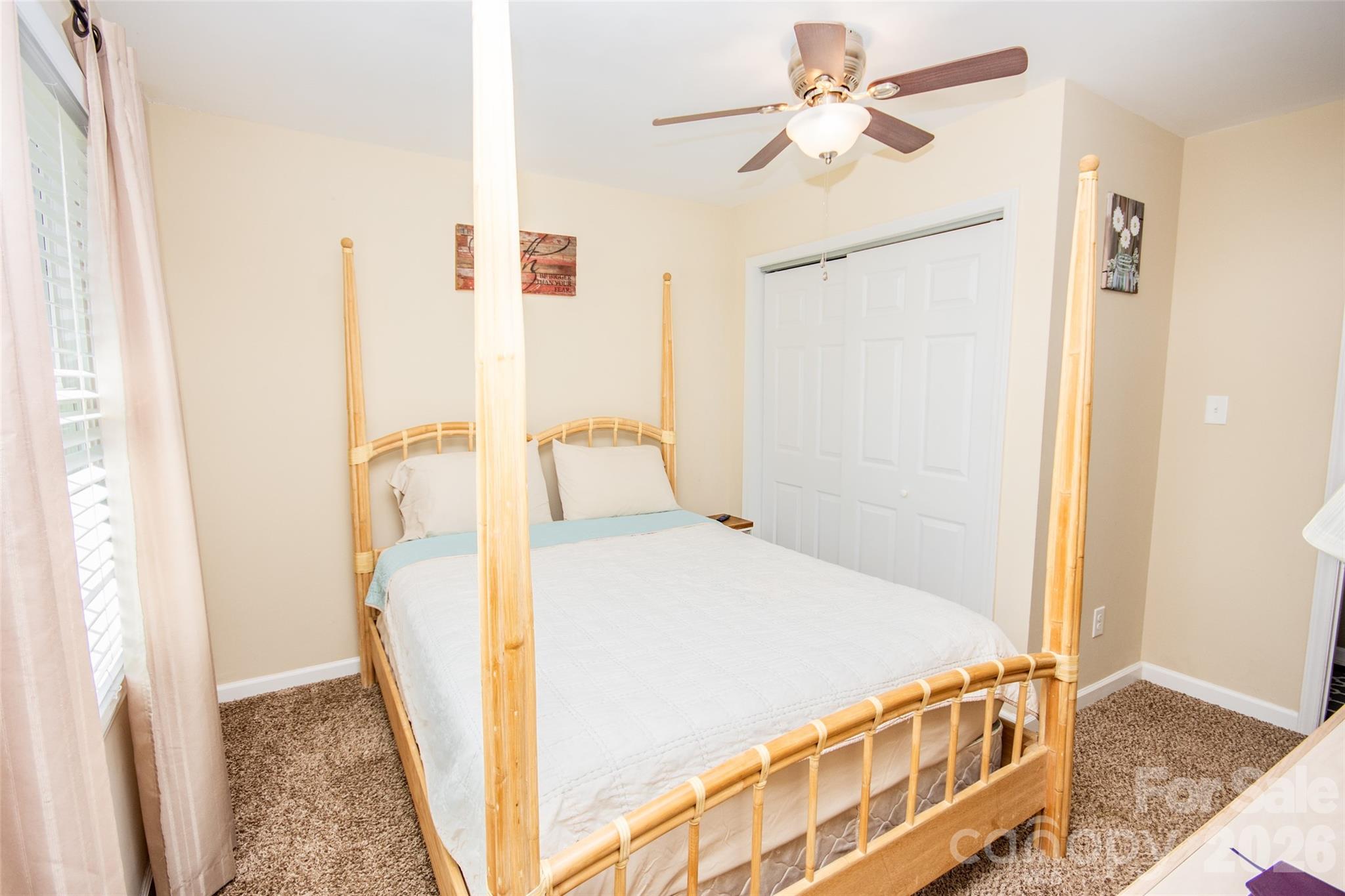 455 Mitch Road Union Grove, NC 28689 - Photo 24 of 44 a bedroom with a bed and a chandelier