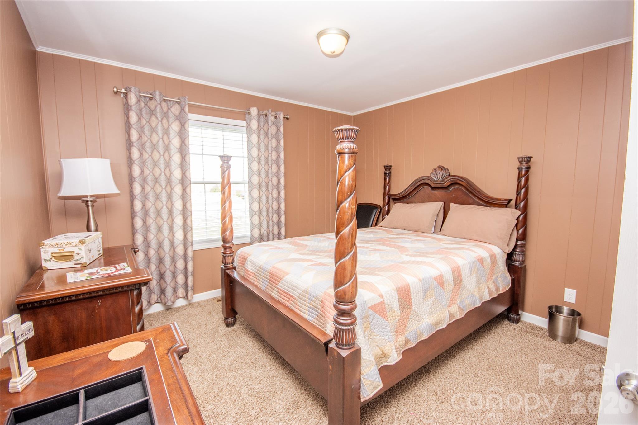 455 Mitch Road Union Grove, NC 28689 - Photo 26 of 44 a bed sitting in a bedroom next to a window