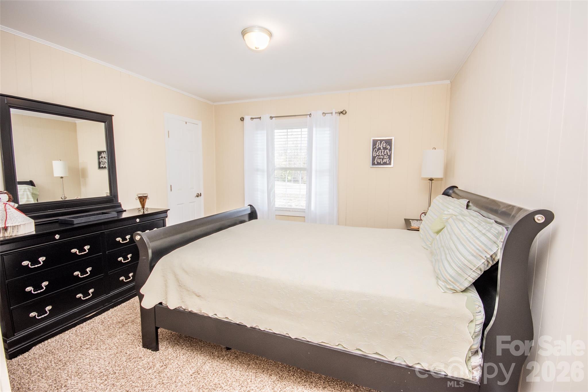 455 Mitch Road Union Grove, NC 28689 - Photo 28 of 44 a bedroom with a bed and a dresser with mirror