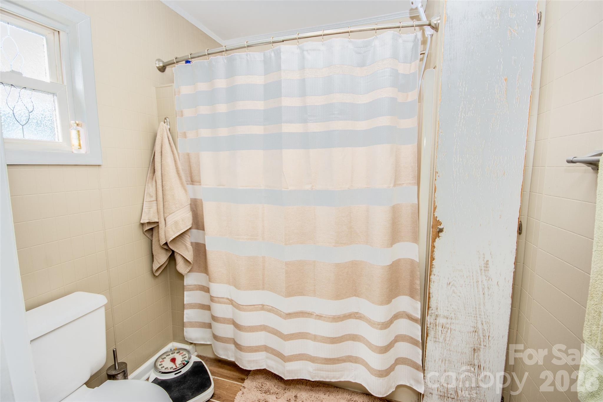455 Mitch Road Union Grove, NC 28689 - Photo 34 of 44 a bathroom with a shower curtain and a window