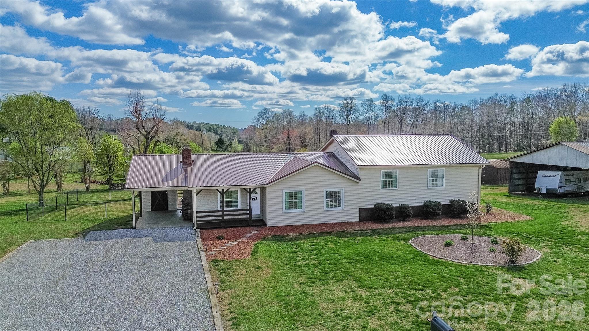455 Mitch Road Union Grove, NC 28689 - Photo 10 of 44 a front view of a house with a garden and trees