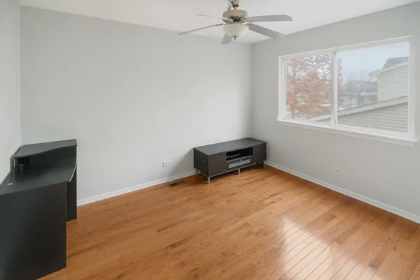 a view of room with hardwood floor and window