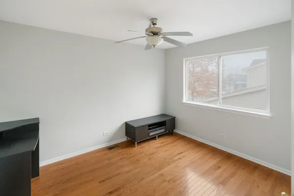 a view of a room with wooden floor and windows