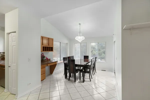 a view of a dining room with furniture and chandelier