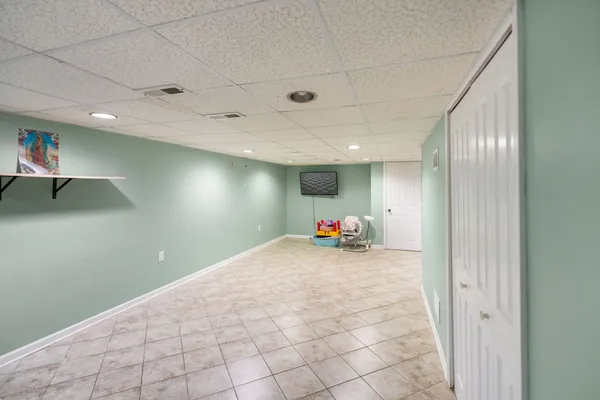 a view of a hallway to room with wooden floor