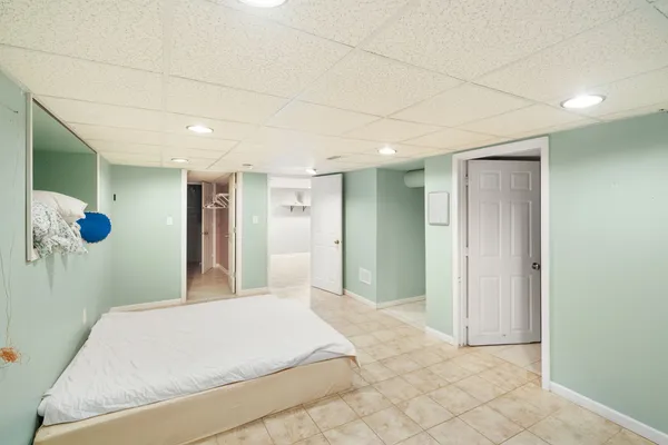 a bedroom with a bed and a mirror