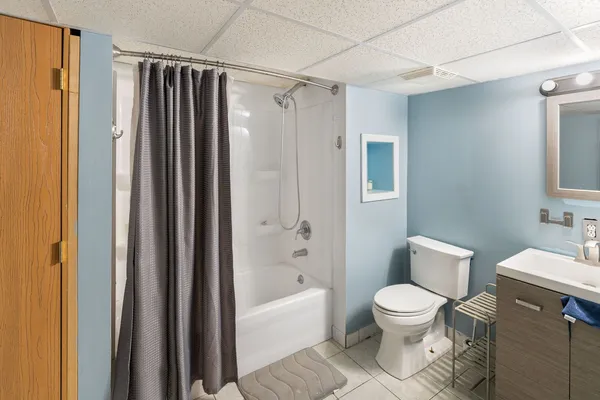a white toilet sitting next to a bathroom sink