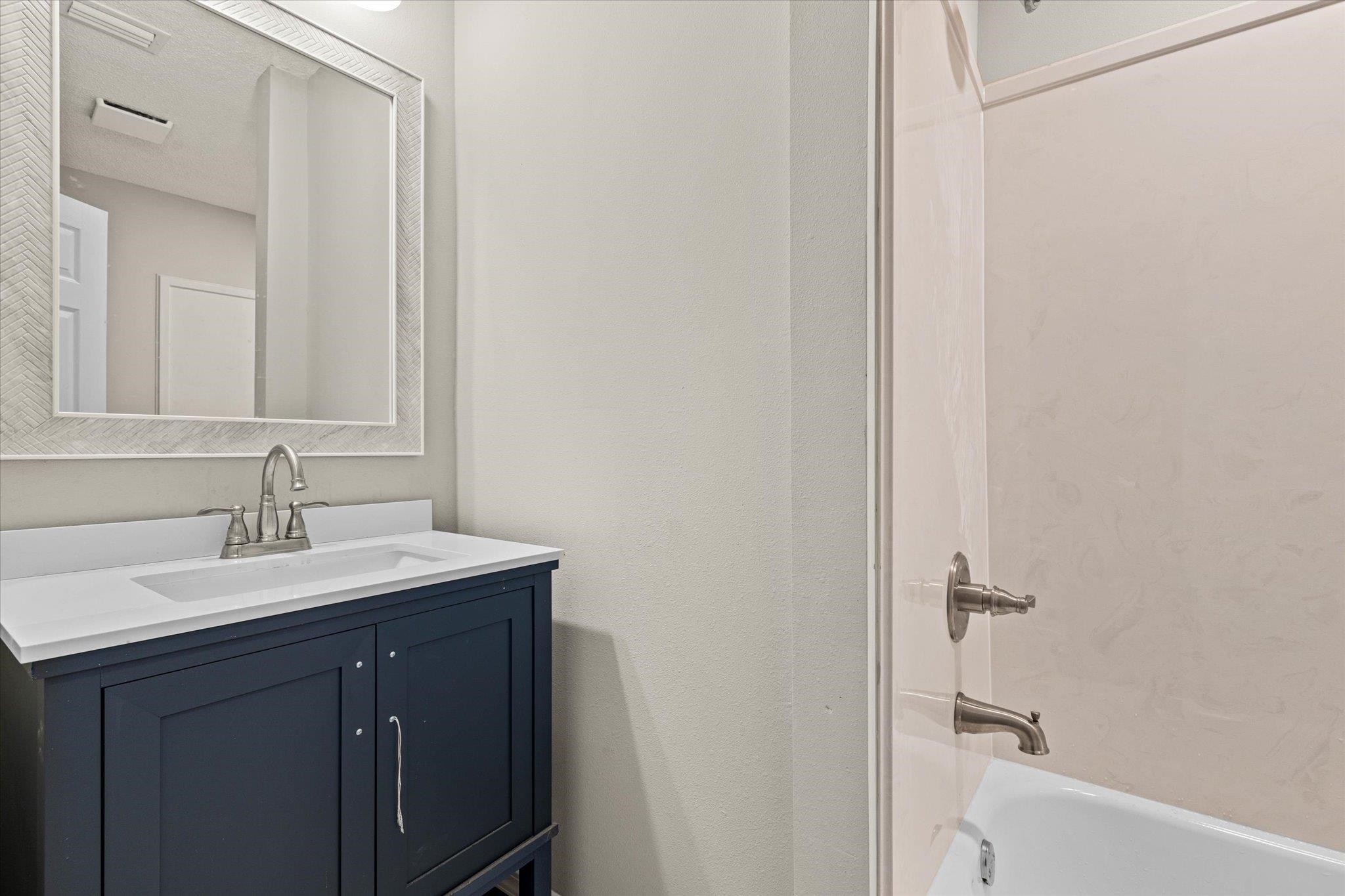 4700 Bit And Spur Road Mobile, AL 36608 - Photo 15 of 21 Full bath featuring vanity and bathing tub / shower combination