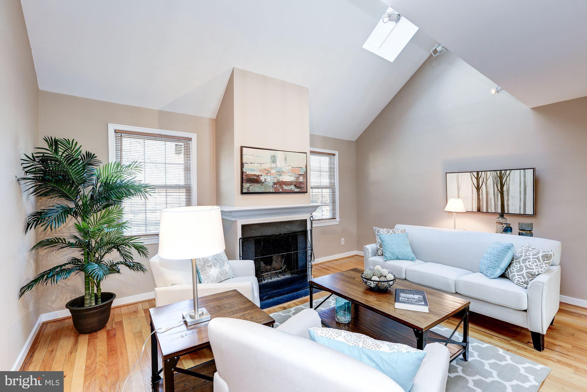 2248 Washington Avenue, Unit 203 Silver Spring, MD 20910 - Photo 1 of 29 a living room with furniture and a fireplace