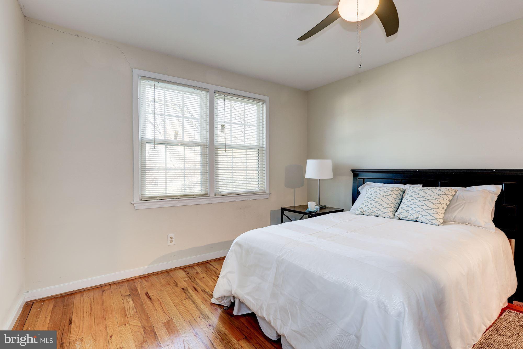 2248 Washington Avenue, Unit 203 Silver Spring, MD 20910 - Photo 16 of 29 a bedroom with a bed and wooden floor