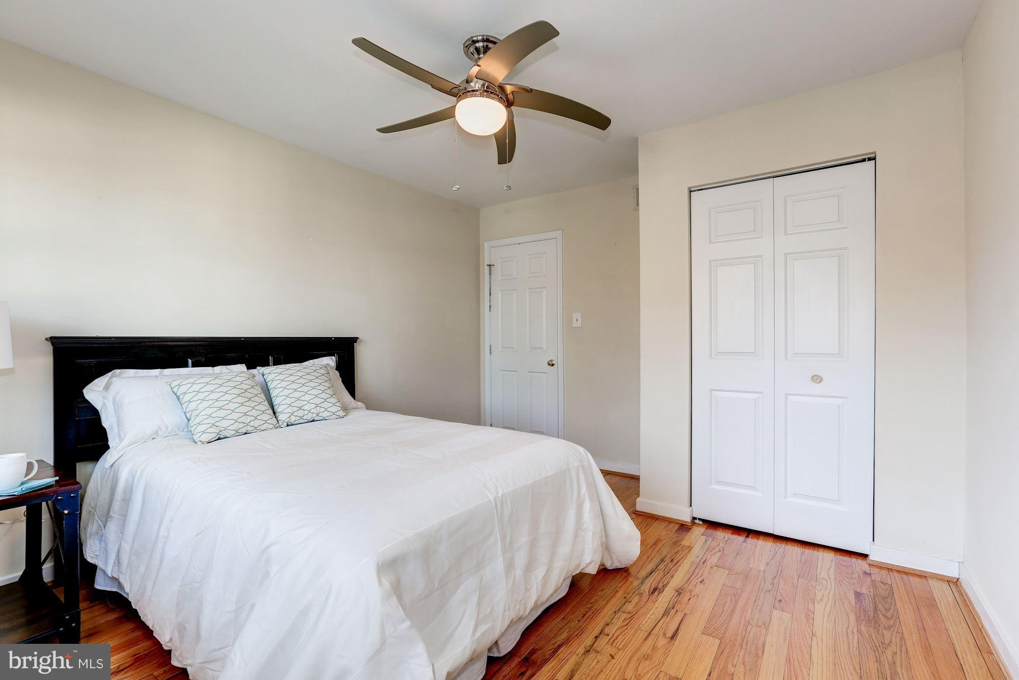 2248 Washington Avenue, Unit 203 Silver Spring, MD 20910 - Photo 17 of 29 a bedroom with a bed and a chandelier