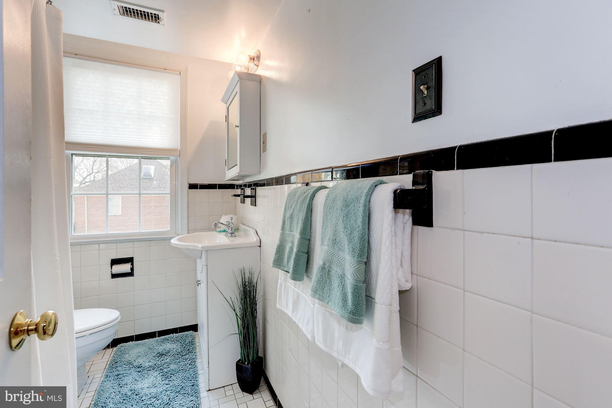 2248 Washington Avenue, Unit 203 Silver Spring, MD 20910 - Photo 18 of 29 a bathroom with a sink toilet and shower