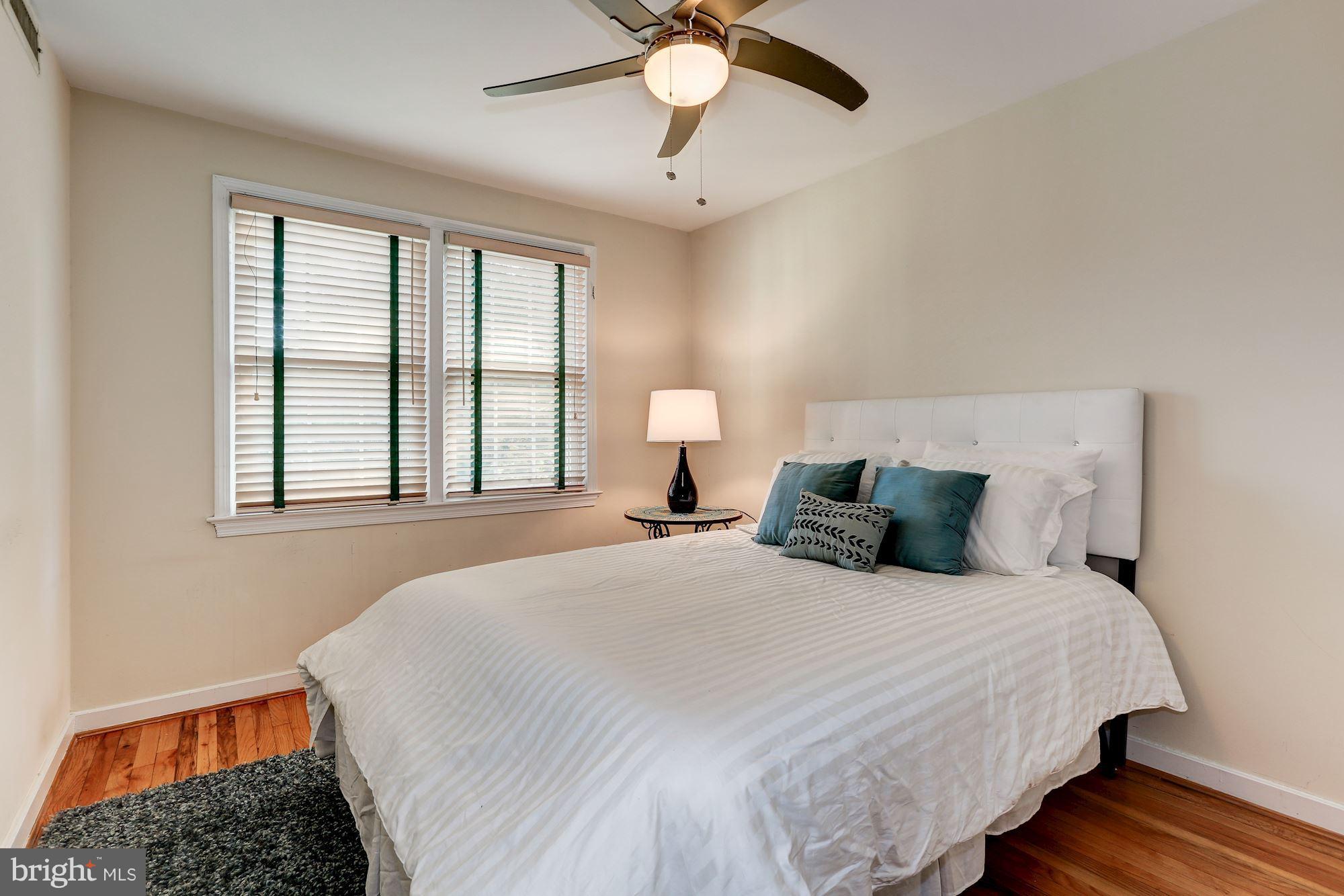 2248 Washington Avenue, Unit 203 Silver Spring, MD 20910 - Photo 21 of 29 a bedroom with a bed and a chandelier