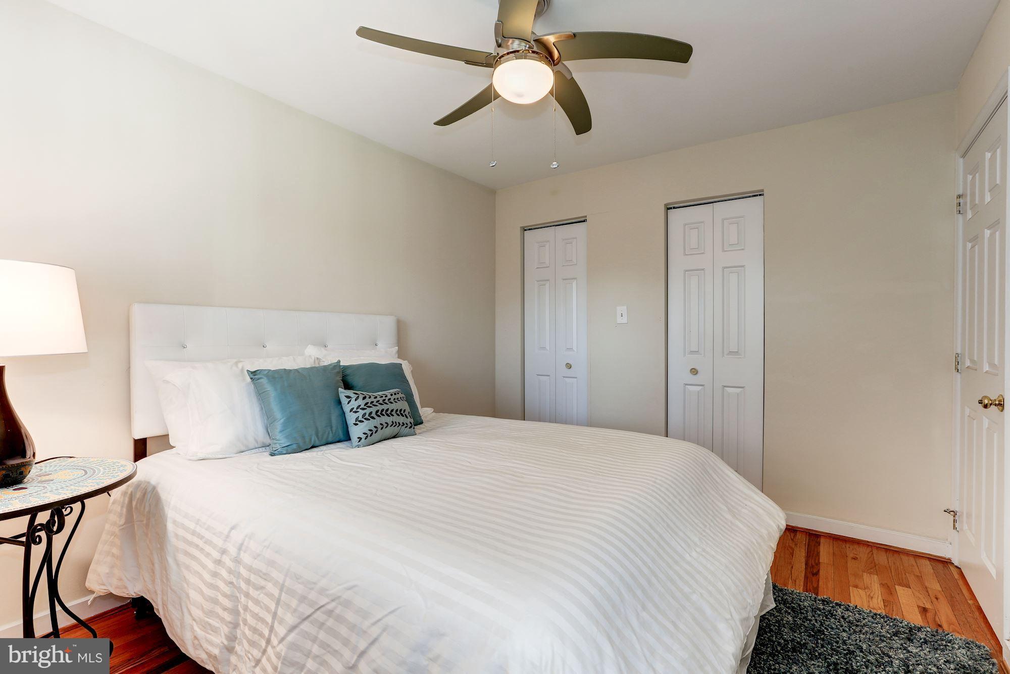 2248 Washington Avenue, Unit 203 Silver Spring, MD 20910 - Photo 22 of 29 a bedroom with a bed and a chandelier