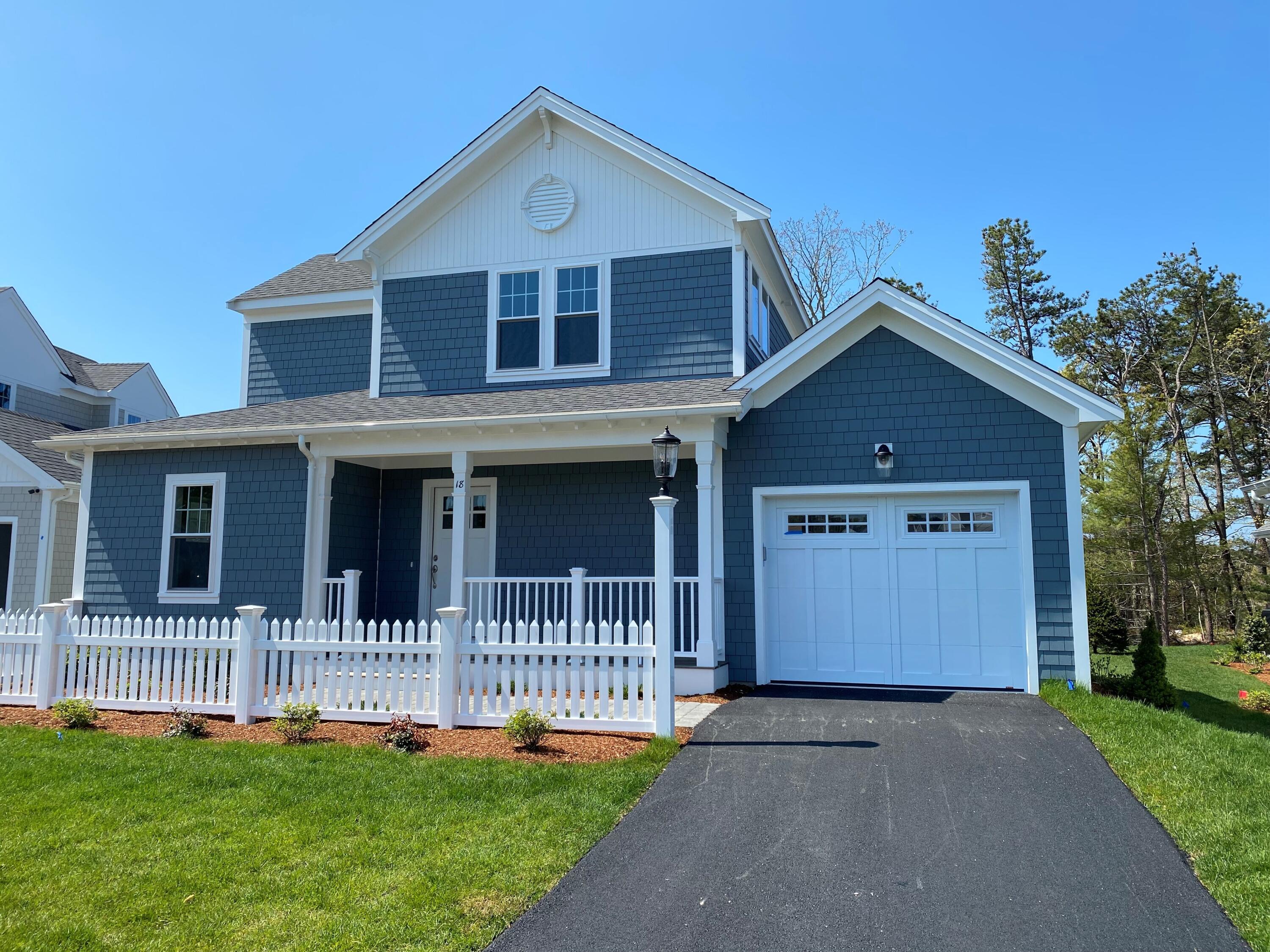 18 Cobblestone Circle Mashpee, MA 02649 - Photo 1 of 41 a front view of a house with a yard
