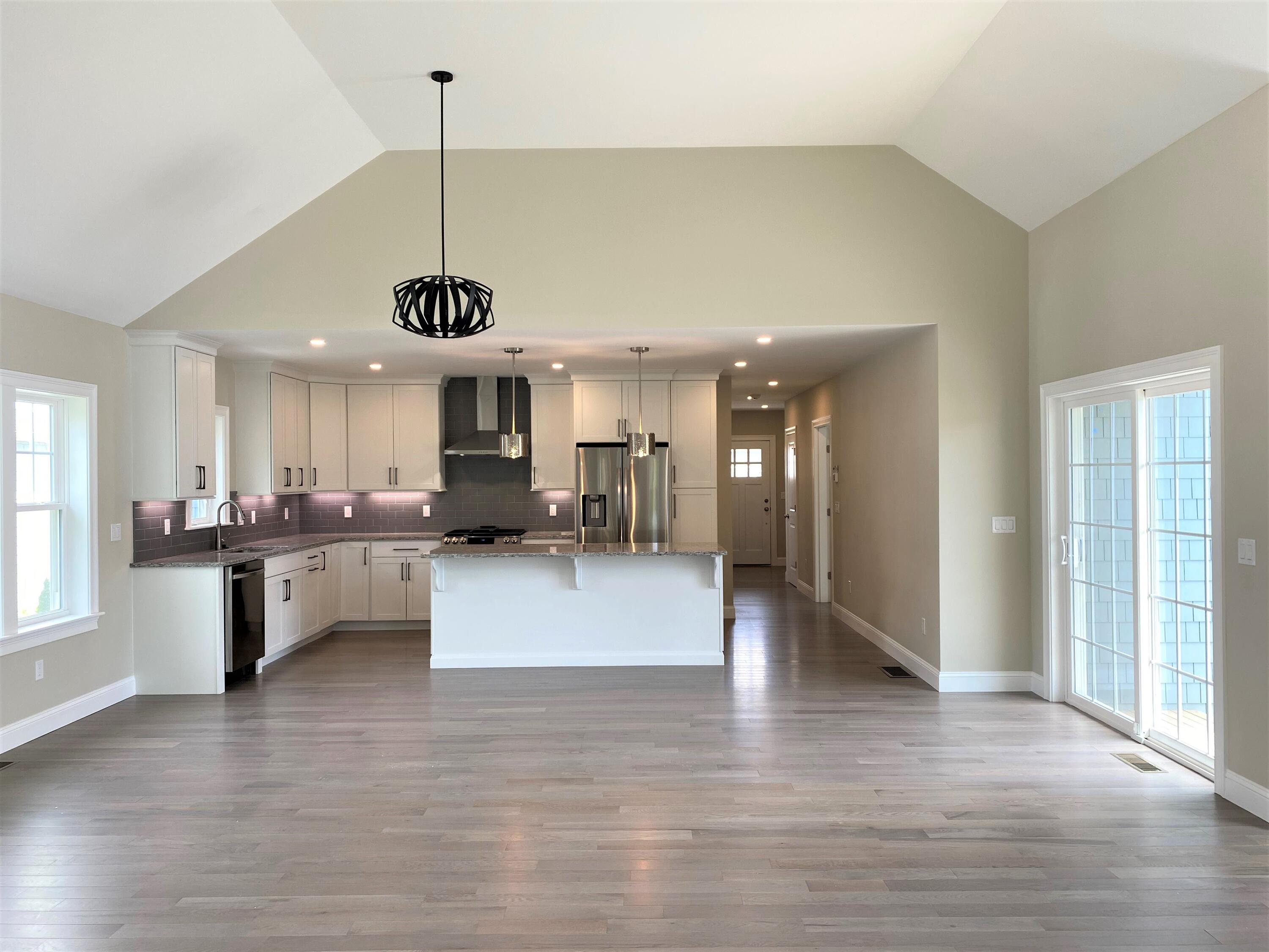 18 Cobblestone Circle Mashpee, MA 02649 - Photo 11 of 41 a view of a kitchen with granite countertop a large counter top a sink stainless steel appliances and cabinets