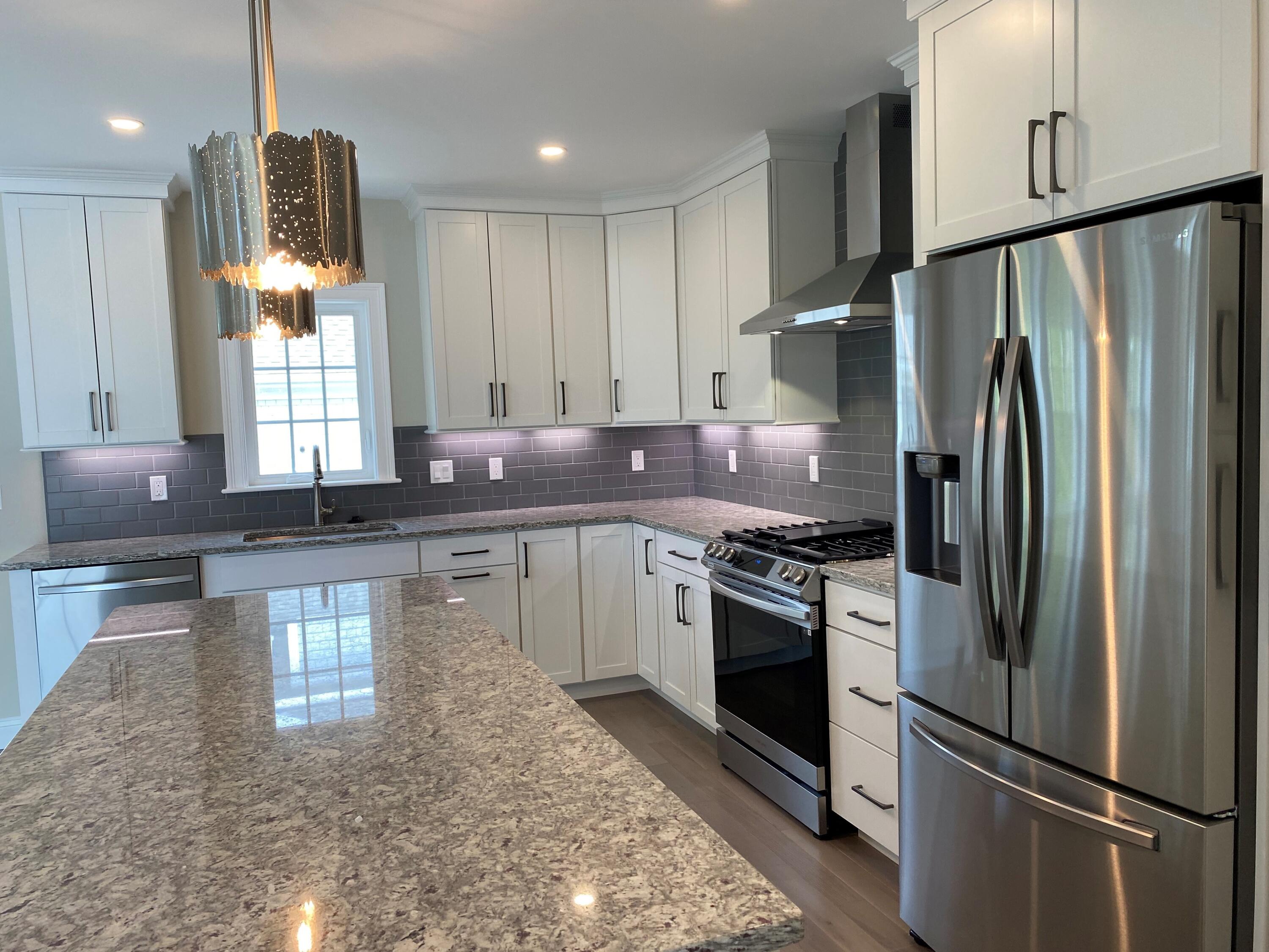18 Cobblestone Circle Mashpee, MA 02649 - Photo 13 of 41 a kitchen with stainless steel appliances granite countertop a refrigerator a stove a sink and a microwave