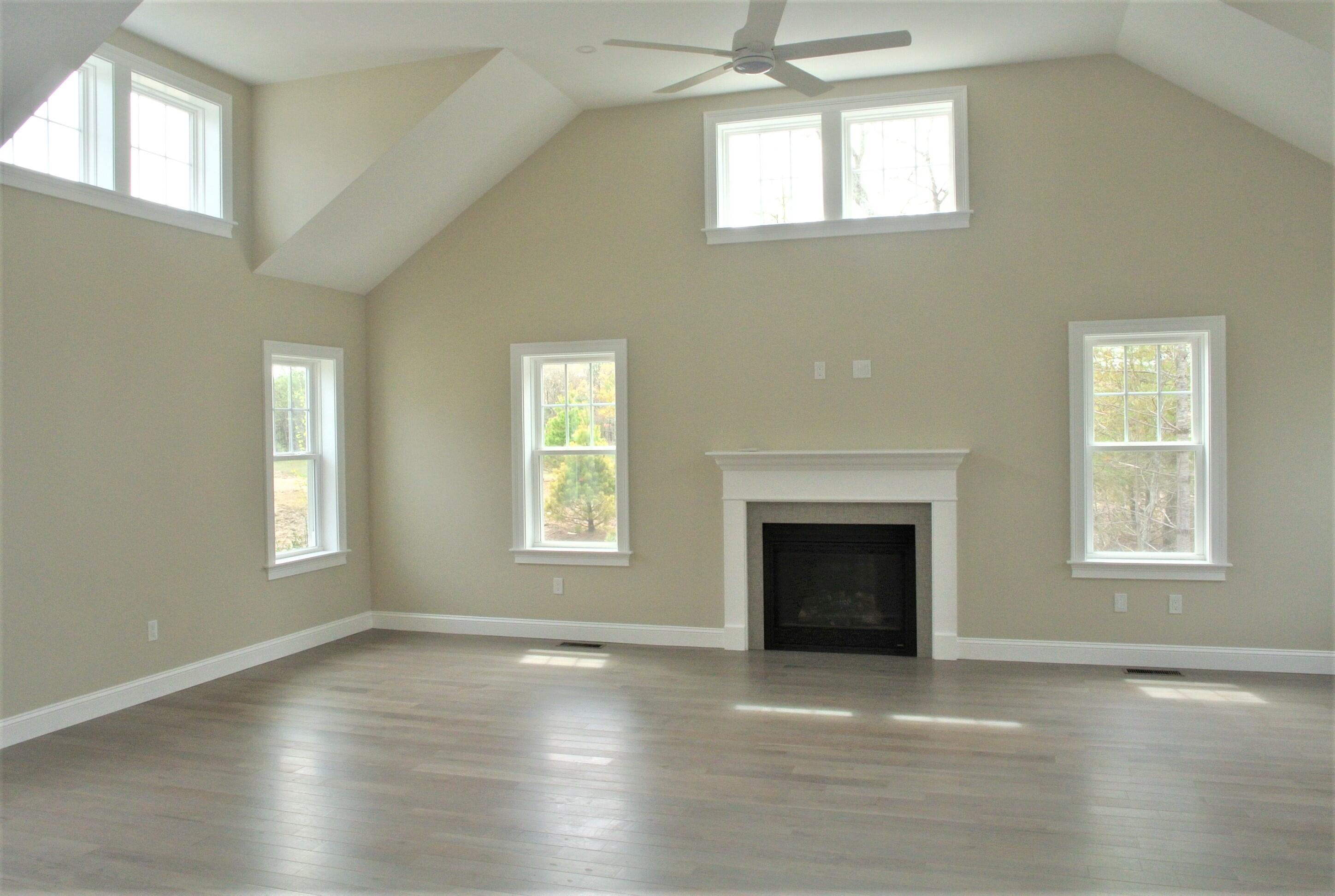 18 Cobblestone Circle Mashpee, MA 02649 - Photo 14 of 41 an empty room with windows and fireplace