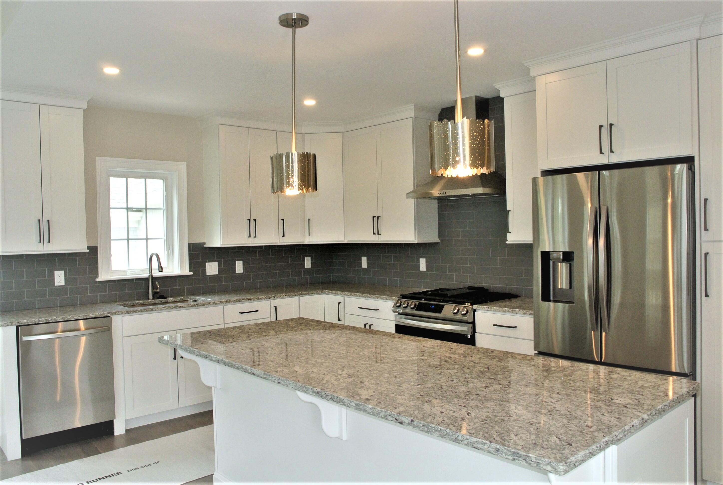 18 Cobblestone Circle Mashpee, MA 02649 - Photo 2 of 41 a kitchen with granite countertop a refrigerator a sink and white cabinets