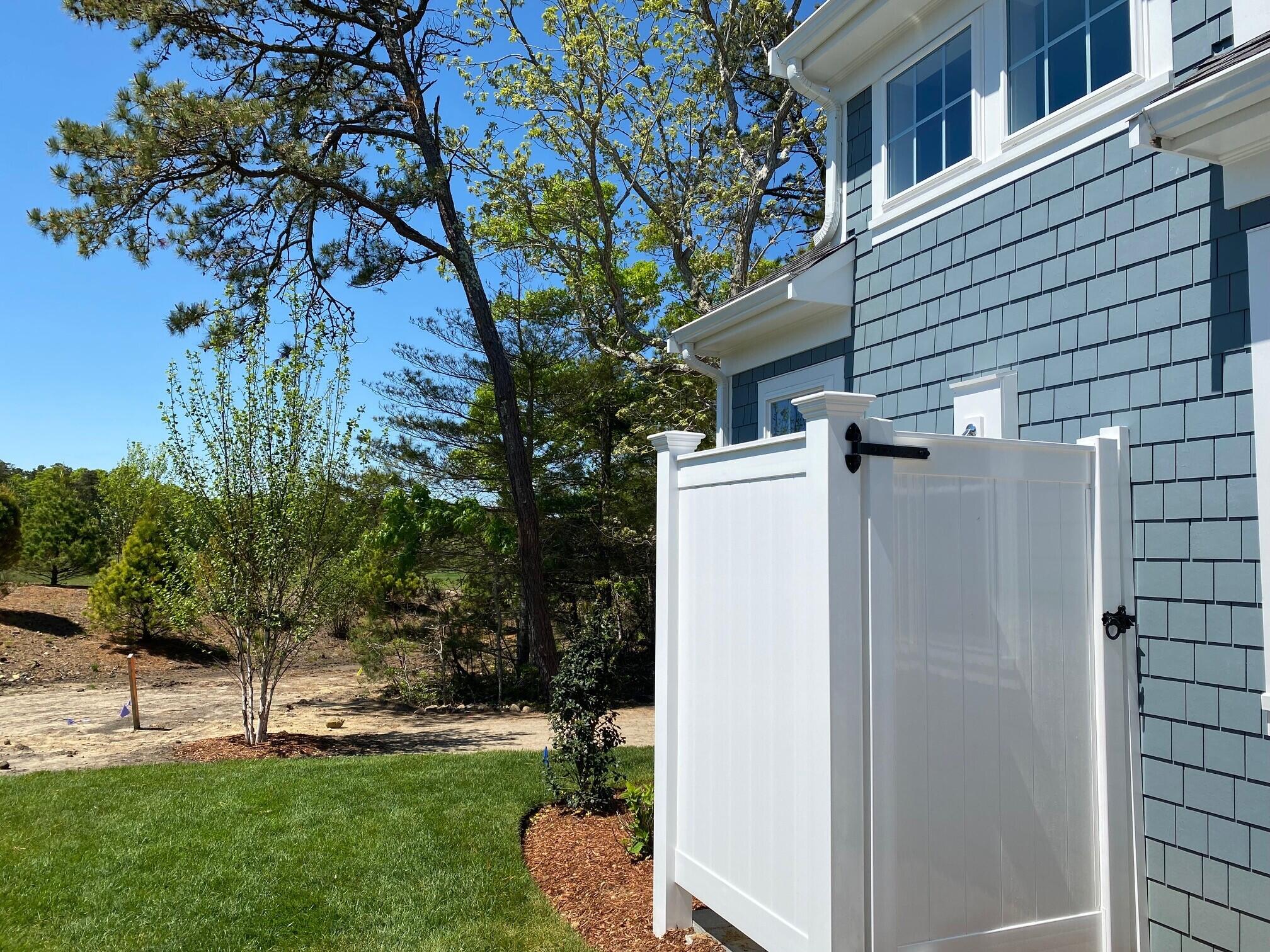 18 Cobblestone Circle Mashpee, MA 02649 - Photo 33 of 41 a view of a white house with a yard and a large tree