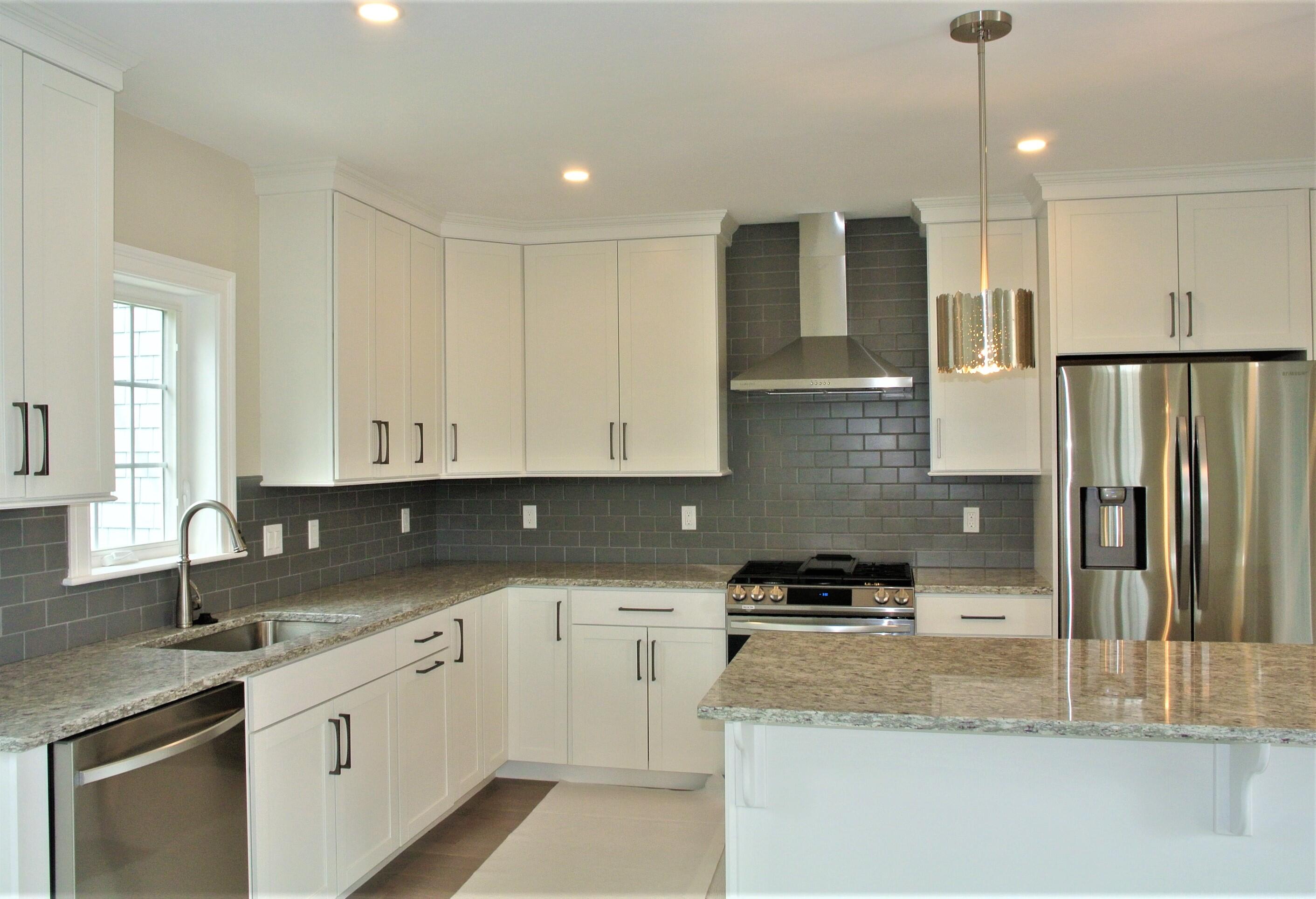18 Cobblestone Circle Mashpee, MA 02649 - Photo 5 of 41 a kitchen with stainless steel appliances granite countertop a sink stove and cabinets