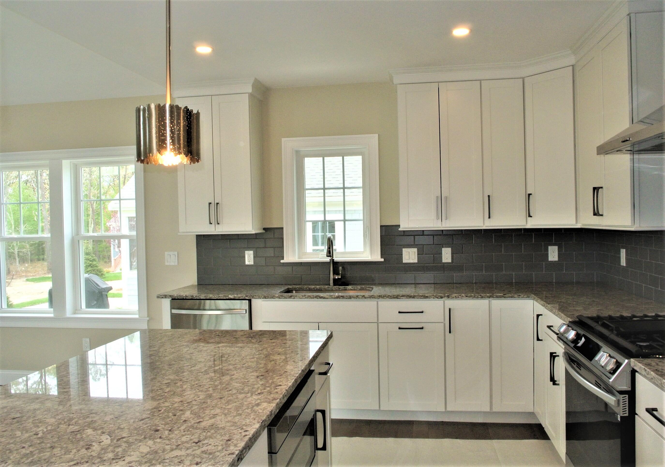 18 Cobblestone Circle Mashpee, MA 02649 - Photo 6 of 41 a kitchen with granite countertop a sink a stove and cabinets