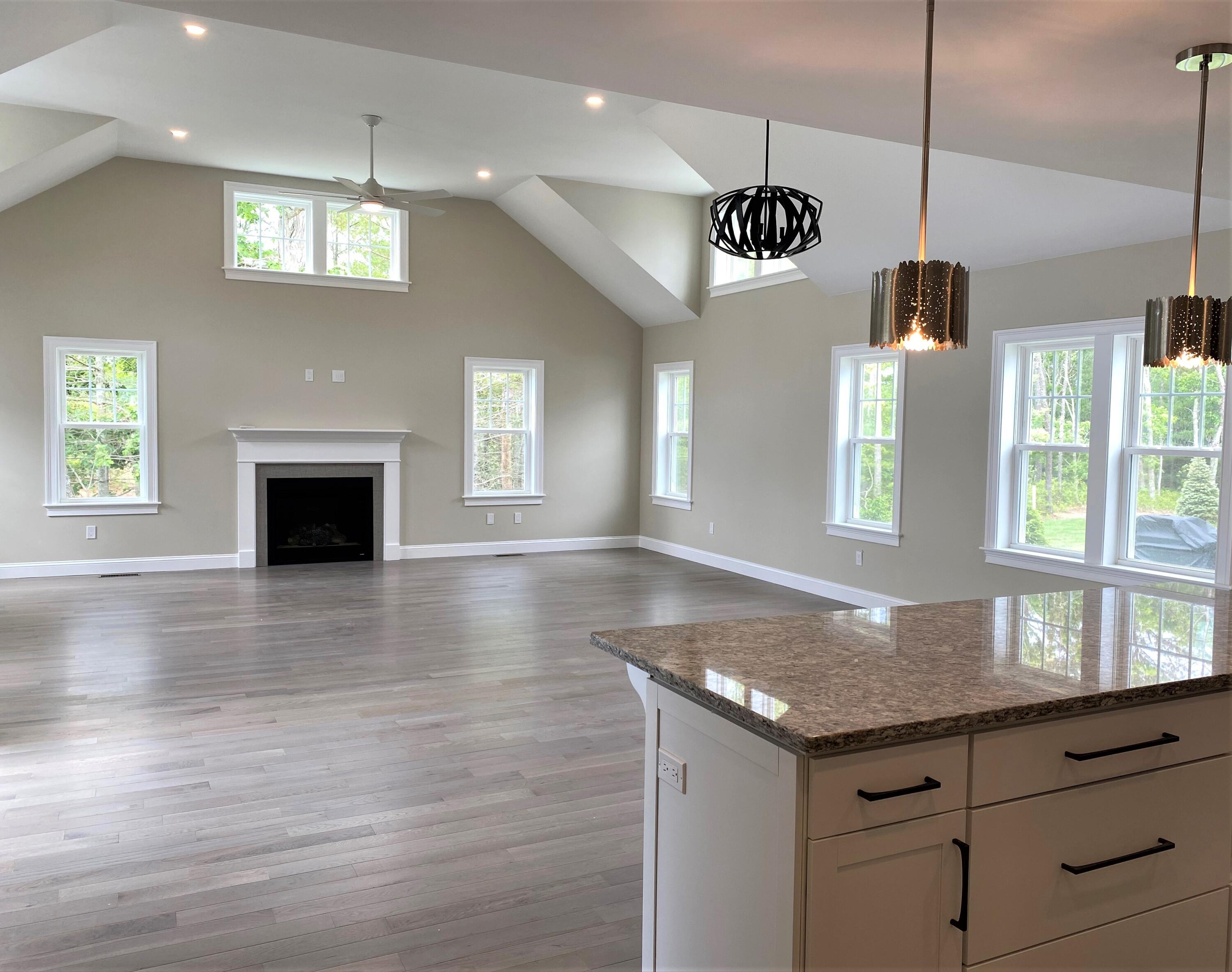 18 Cobblestone Circle Mashpee, MA 02649 - Photo 7 of 41 a kitchen with granite countertop kitchen island a stove a sink a window and wooden floor