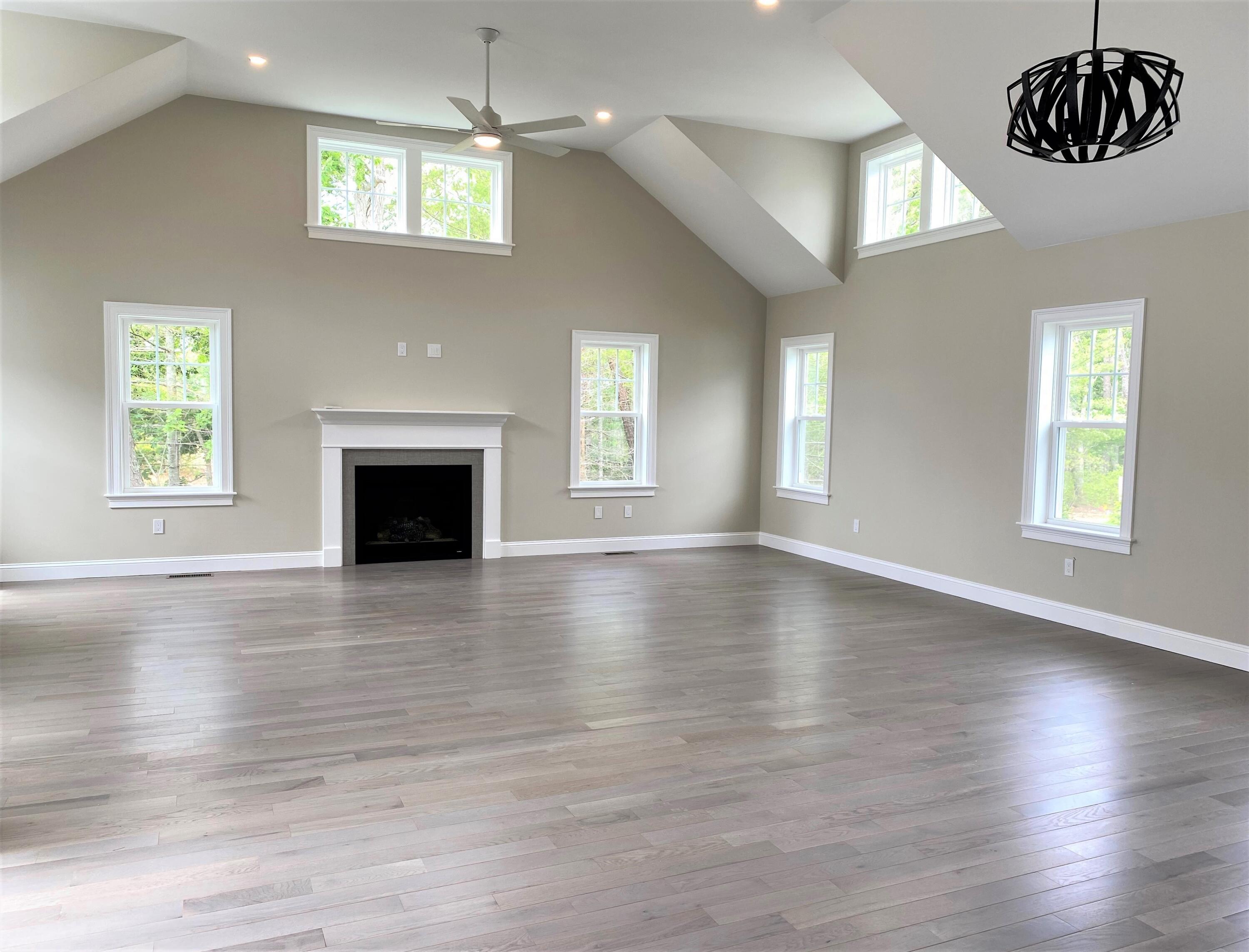18 Cobblestone Circle Mashpee, MA 02649 - Photo 9 of 41 an empty room with wooden floor windows and fireplace